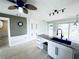 Bright kitchen island with sink and granite counter, complemented by white cabinetry at 104 Pops Ln, Nokomis, FL 34275