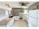 Bright kitchen features granite counters, modern fixtures, and stainless steel refrigerator at 104 Pops Ln, Nokomis, FL 34275