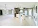 Open-concept kitchen features granite island with sink and views to the living space at 104 Pops Ln, Nokomis, FL 34275
