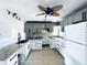 Bright kitchen featuring granite countertops, and gray and white cabinets and modern appliances at 104 Pops Ln, Nokomis, FL 34275