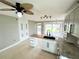 Bright kitchen features granite countertops, island sink, ample cabinetry, and backyard access at 104 Pops Ln, Nokomis, FL 34275