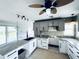 Bright kitchen featuring granite countertops, and gray and white cabinets and modern appliances at 104 Pops Ln, Nokomis, FL 34275