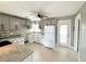 Bright kitchen features granite countertops, modern fixtures, and a white refrigerator at 104 Pops Ln, Nokomis, FL 34275