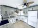 Well-lit kitchen features gray and white cabinets, granite countertops, and black hardware at 104 Pops Ln, Nokomis, FL 34275