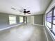 Well-lit living room with large windows and gray-painted walls at 104 Pops Ln, Nokomis, FL 34275