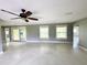 Bright living room with natural light, neutral walls and ceiling fan at 104 Pops Ln, Nokomis, FL 34275
