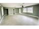 Open living room with a ceiling fan and access to other areas at 104 Pops Ln, Nokomis, FL 34275