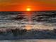 Ocean view of sun setting over the waves creating a vivid orange sky at 104 Pops Ln, Nokomis, FL 34275