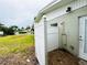 Secluded outdoor shower area features tiled flooring, privacy fencing, and convenient backyard access at 104 Pops Ln, Nokomis, FL 34275