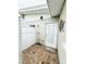 Private outdoor shower with tiled floor, white privacy screen, and easy access to the home at 104 Pops Ln, Nokomis, FL 34275