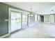 Living room with sliding glass doors leading to a covered patio and backyard at 104 Pops Ln, Nokomis, FL 34275
