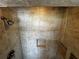 Tiled shower features a shower head and a built-in shelf, offering a comfortable and stylish showering experience at 104 Pops Ln, Nokomis, FL 34275