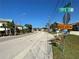 Street view of a dead end, surrounded by sidewalks, homes, and trees at 104 Pops Ln, Nokomis, FL 34275