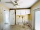 Utility room with white cabinets, a ceiling fan, yellow walls, and plumbing fixtures at 104 Pops Ln, Nokomis, FL 34275