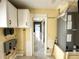 Utility room with white cabinets, yellow walls, HVAC equipment, and plumbing fixtures at 104 Pops Ln, Nokomis, FL 34275