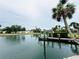 Scenic waterfront view featuring a private dock, tranquil water, and lush landscaping for serene living at 104 Pops Ln, Nokomis, FL 34275