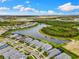 An aerial view shows the community's well-planned layout with homes surrounding a picturesque lake at 10868 Sun Drop St, Venice, FL 34293