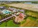 Aerial view of community amenities: playground, pool, and lush landscaping, all for residents enjoyment at 10868 Sun Drop St, Venice, FL 34293