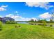 Spacious backyard with a serene pond view, screened-in lanai, and lush landscaping at 10868 Sun Drop St, Venice, FL 34293