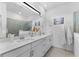 Elegant bathroom with dual sinks, modern fixtures, and a glass-enclosed shower for a spa-like experience at 10868 Sun Drop St, Venice, FL 34293