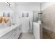 Bright and spacious bathroom featuring a modern vanity, sleek fixtures, and glass-enclosed shower at 10868 Sun Drop St, Venice, FL 34293