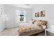 Cozy bedroom with large window, soft carpet, and decor art above the bed at 10868 Sun Drop St, Venice, FL 34293
