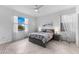 Serene bedroom with comfortable bed, side tables, and windows offering natural light and scenic views at 10868 Sun Drop St, Venice, FL 34293