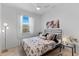 Cozy bedroom with a soft, inviting bed, natural light, and stylish decor for a relaxing atmosphere at 10868 Sun Drop St, Venice, FL 34293