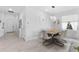 Bright dining room featuring a modern table set, decorative wall clock, and stylish decor at 10868 Sun Drop St, Venice, FL 34293
