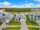 Aerial view of a beautifully landscaped home with a gray tile roof, lush lawn, and paver driveway at 10868 Sun Drop St, Venice, FL 34293