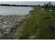 Scenic view of the lakeside walking path with newly planted trees, rock shoreline, and peaceful surroundings at 10868 Sun Drop St, Venice, FL 34293
