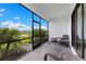 Lanai with furniture and screen, overlooking a serene pond and landscape at 10868 Sun Drop St, Venice, FL 34293