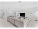 Bright living room with a large sectional sofa, modern decor, and an adjacent dining area at 10868 Sun Drop St, Venice, FL 34293