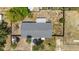 Aerial shot of the home's roof and backyard, highlighting the yard's fencing and mature trees at 112 E Marland Ct, Nokomis, FL 34275