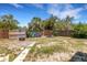 Backyard featuring a fence and tropical landscaping at 112 E Marland Ct, Nokomis, FL 34275