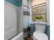 Bathroom showcasing tub/shower combo, toilet, and window, with shower curtain at 112 E Marland Ct, Nokomis, FL 34275
