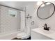 Bathroom featuring a new vanity, a round mirror, a white tiled shower, and modern fixtures at 112 E Marland Ct, Nokomis, FL 34275