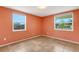 Bright bedroom featuring tile flooring, two windows, and neutral wall color for a relaxing atmosphere at 112 E Marland Ct, Nokomis, FL 34275