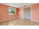 Well-lit bedroom with tile floors, a large window, and closet providing ample space and natural light at 112 E Marland Ct, Nokomis, FL 34275