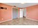 Cozy bedroom boasts tile flooring, closet, and neutral paint, creating a tranquil living space at 112 E Marland Ct, Nokomis, FL 34275