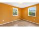 Bright bedroom with two windows offering natural light and backyard views at 112 E Marland Ct, Nokomis, FL 34275