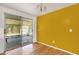 Dining room with a bright yellow wall and sliding door access to the outdoor patio at 112 E Marland Ct, Nokomis, FL 34275