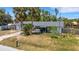 Exterior of home with palm trees, front yard, and small garden bed by the front entrance at 112 E Marland Ct, Nokomis, FL 34275