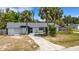 Exterior of home with a long driveway and two palm trees, showing the home's curb appeal at 112 E Marland Ct, Nokomis, FL 34275