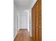 Hallway with wood flooring and closet adding warmth and character to the home's interior at 112 E Marland Ct, Nokomis, FL 34275