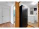 Hallway with hardwood flooring and a linen closet leading to a bathroom and laundry area at 112 E Marland Ct, Nokomis, FL 34275