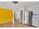 Bright kitchen area featuring stainless steel refrigerator and a view into other rooms at 112 E Marland Ct, Nokomis, FL 34275