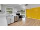 Modern kitchen features white cabinets, stainless steel appliances, and hardwood floors at 112 E Marland Ct, Nokomis, FL 34275