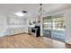 Bright kitchen with white cabinets, stainless steel appliances, and sliding door access to the outdoor patio at 112 E Marland Ct, Nokomis, FL 34275