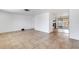 Open floor plan with tile flooring, leading to the kitchen with stainless steel appliances at 112 E Marland Ct, Nokomis, FL 34275